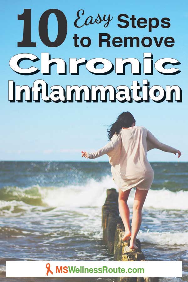Woman walking on old wooden sand fence post in ocean near the shoreline with overlay: 10 Easy Steps to Remove Chronic Inflammation