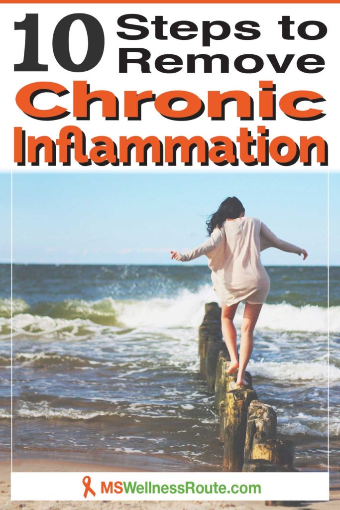Pinterest pin with woman walking on old wooden sand fence post in ocean near the shoreline with header: 10 Steps to Remove Chronic Inflammation