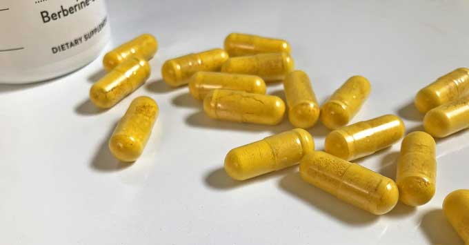 Bottle of berberine with yellow capsules 