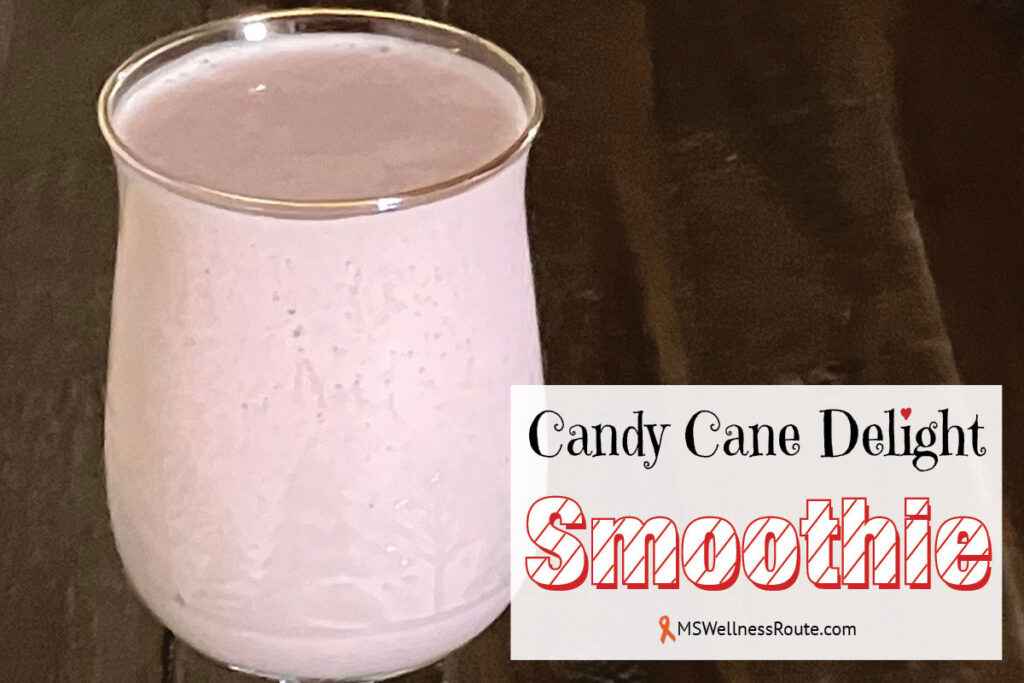 Pink smoothie in a glass on dark background with overlay: Candy Cane Delight Smoothie