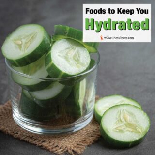 Fresh cucumbers sliced on dark background with overlay: Foods to Keep You Hydrated.