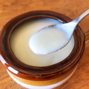 Cauliflower soup in a bowl with spoon.