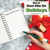 Woman writing in journal with Christmas decorations with overlay: How to Reset After the Holidays