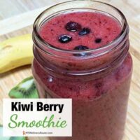 A smoothie with blueberries on top in a glass jar with overlay: Kiwi Berry Smoothie