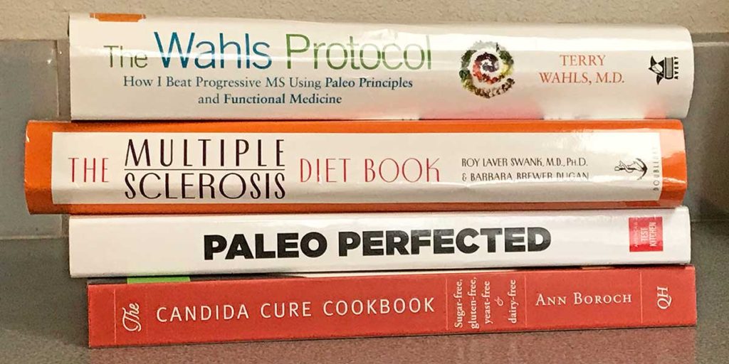 Four books binders, The Wahls Protocol, The MS Diet Book, Paleo Perfected, The Candida Cure Cookbook.