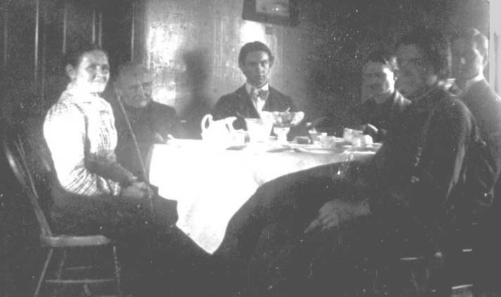 Old picture from 1800s of family at dinner table.