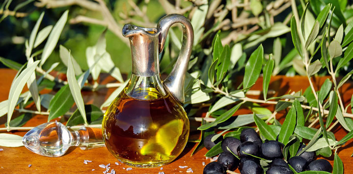 Olive oil decanter with black olives.