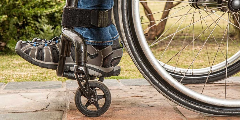 Close-up of someones feet sitting in a wheelchair.