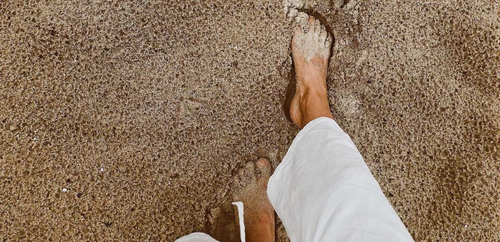 Walking barefoot in sand.