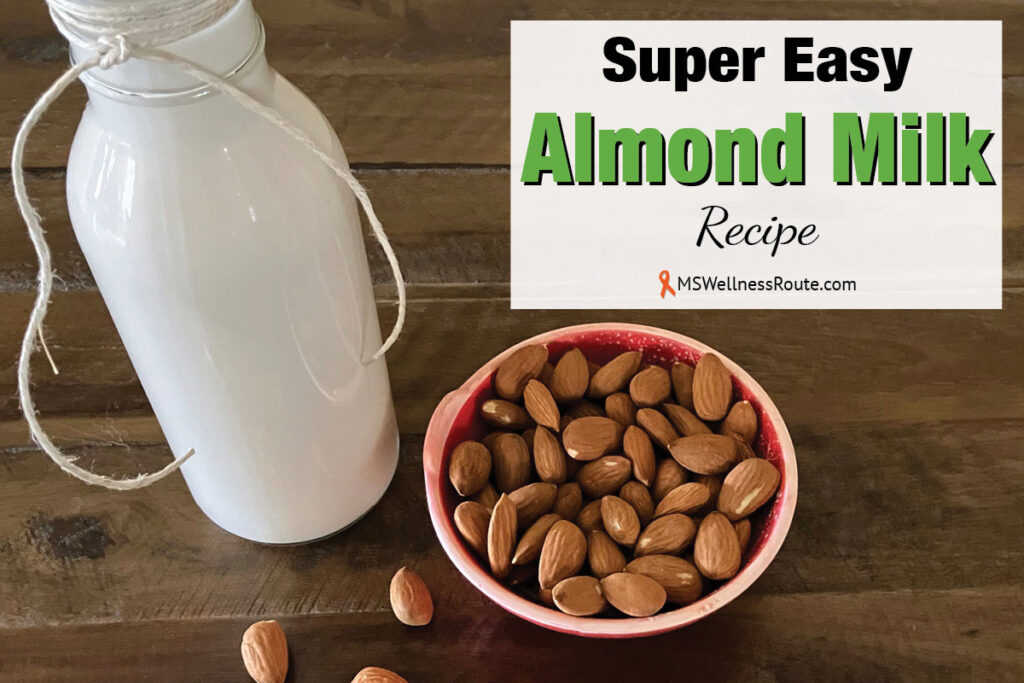 Glass bottle of almond milk with almonds and overlay: Super Easy Almond Milk Recipe