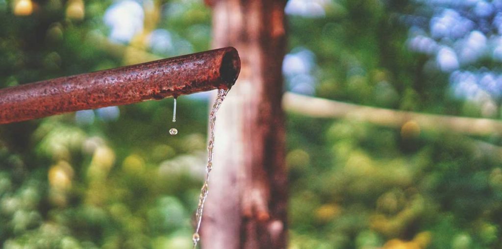 Water running from rusty pipe.