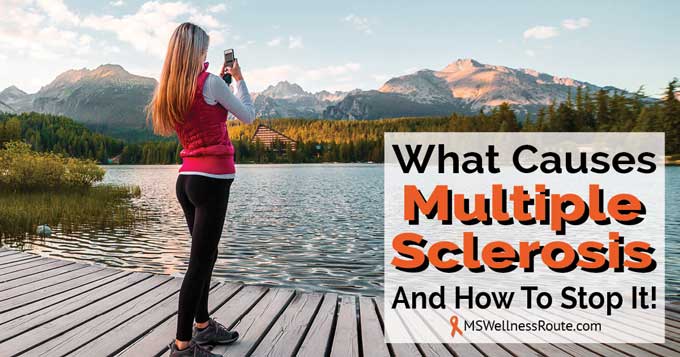 Woman standing on dock taking picture of mountains.