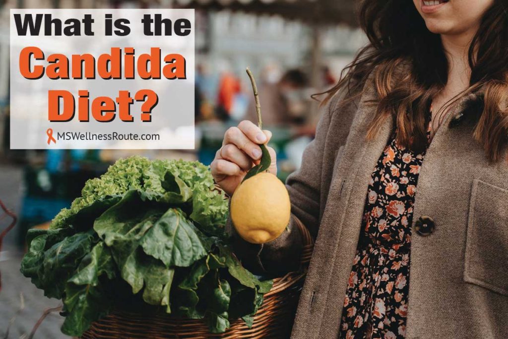 Young woman holding basket of veggies and lemon with overlay: What is the candida diet?