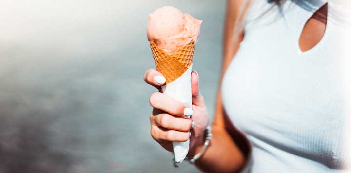 Woman holding an ice cream cone.