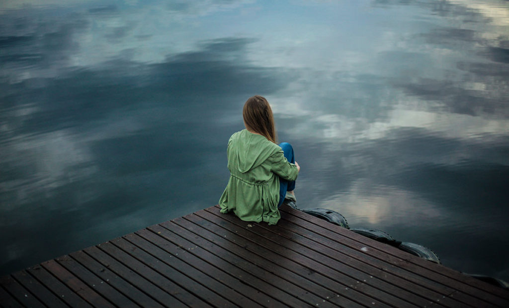 Woman sitting on dock.