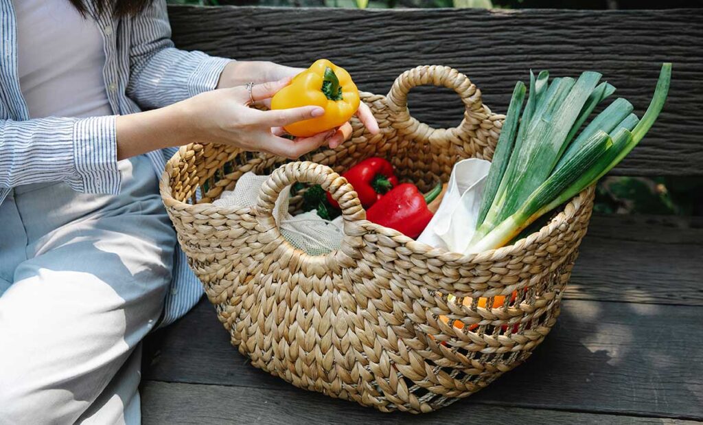 Woman with a basket of veggies.