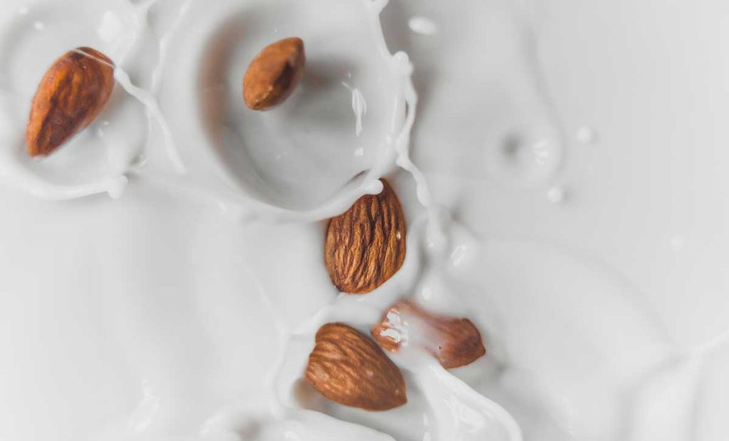 Almonds splashing in almond milk.