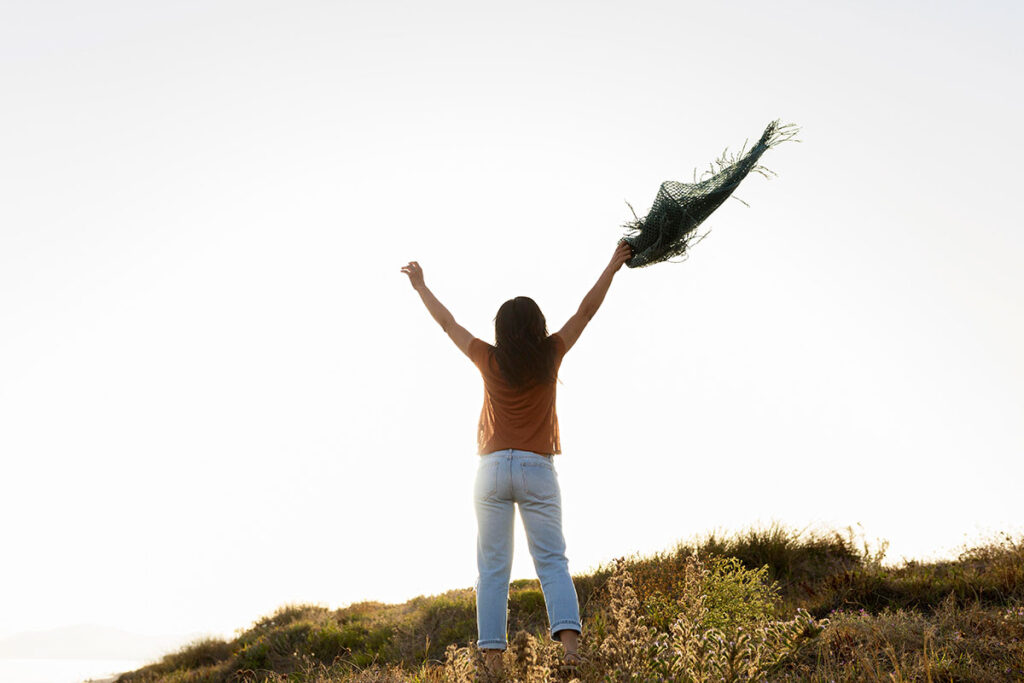 Back view of carefree woman in nature.