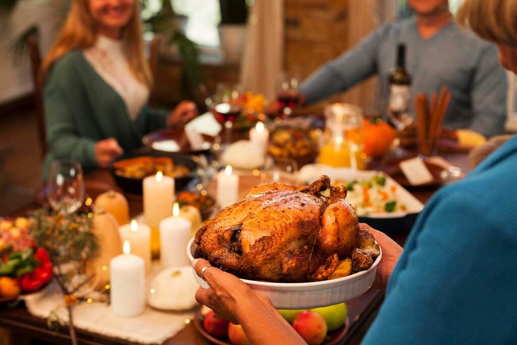 Close up of family members at a holiday dinner table setting.