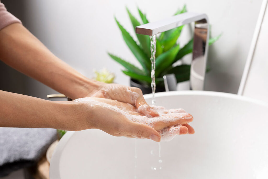 Close up of woman washing her hands with soap.