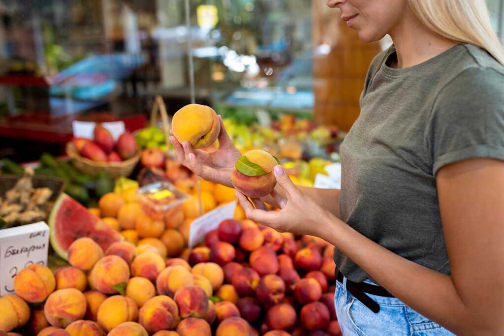 Close up of woman shopping for fruit.