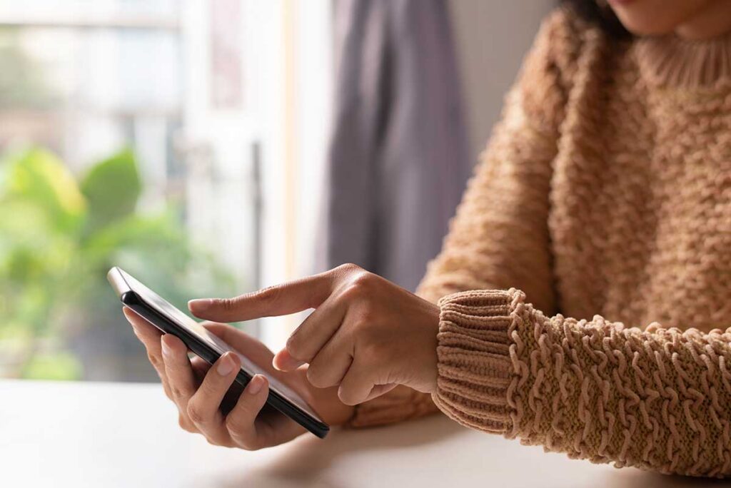 Close up of woman in a sweater viewing 
-up-woman-sweater-viewing-online-information.jpg