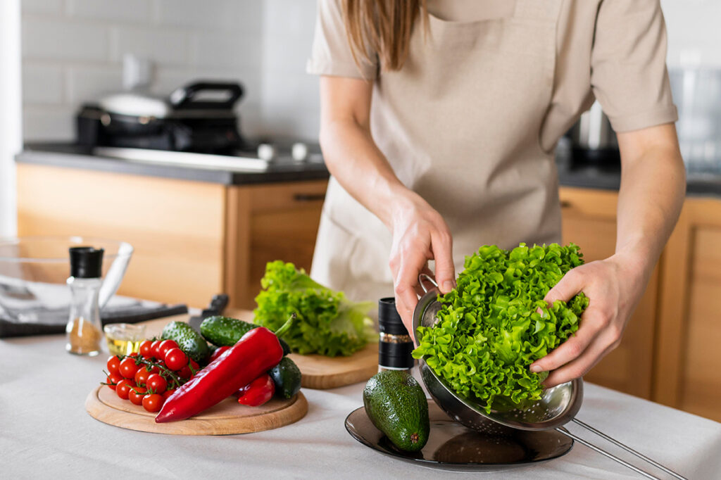 Close-up of woman's hands holding lettuce preparing a meal.