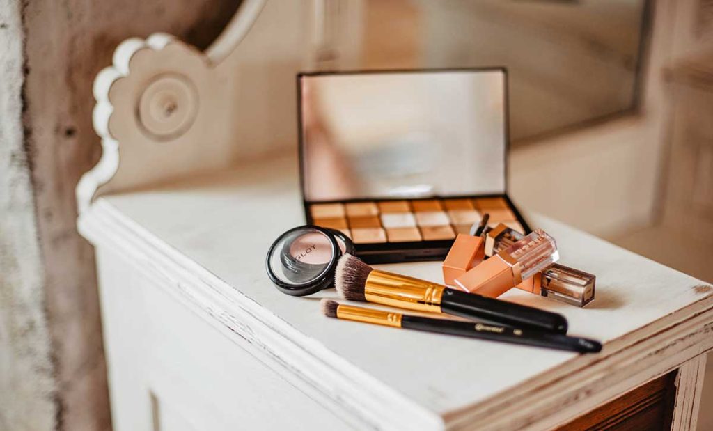 Cosmetics on old vintage makeup vanity.