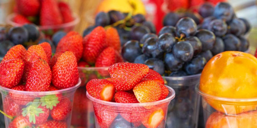 Cup of strawberries and mixed fruit.