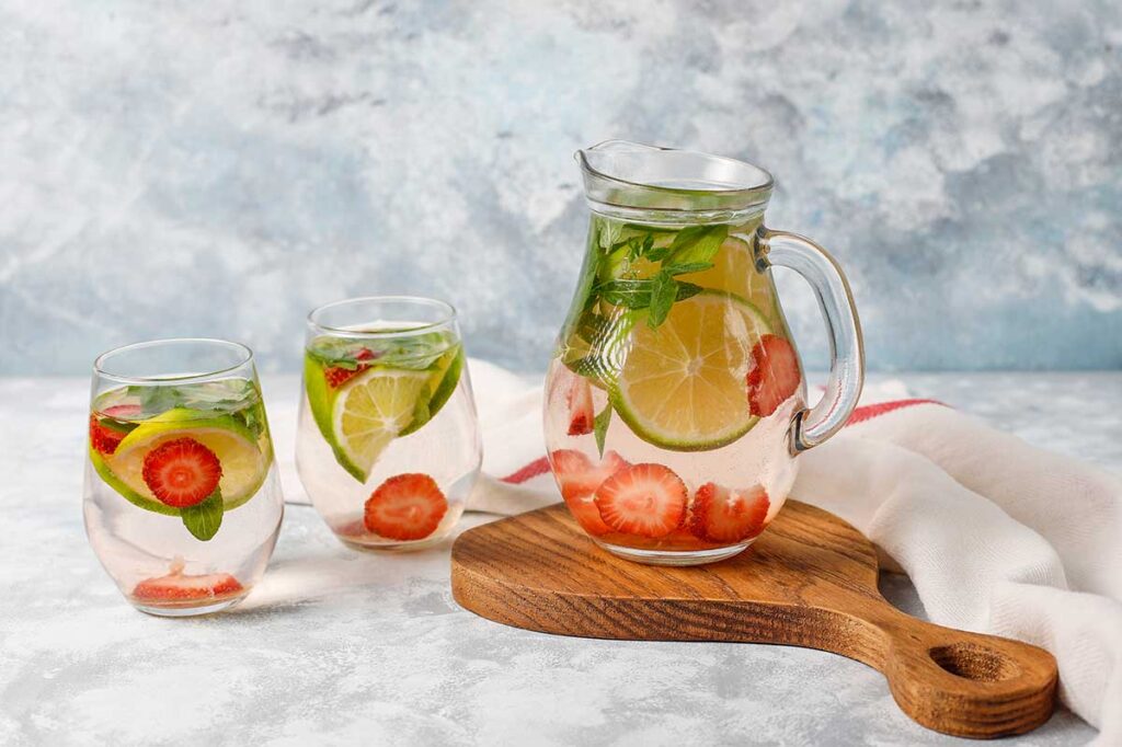 Fresh lime, strawberry and mint infused water, cocktail, detox drink, lemonade. Summer drinks. Health care concept.