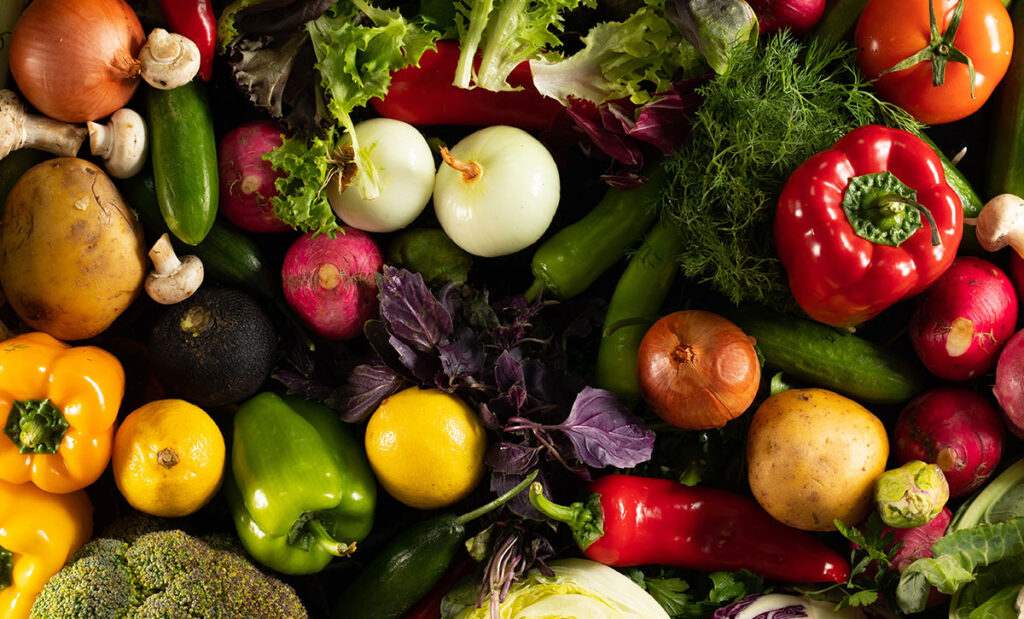 Looking down at fresh veggies on a black background.