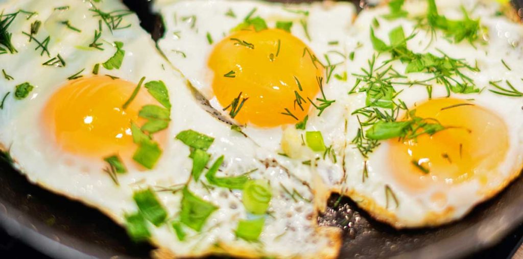 Fried eggs with herbs.