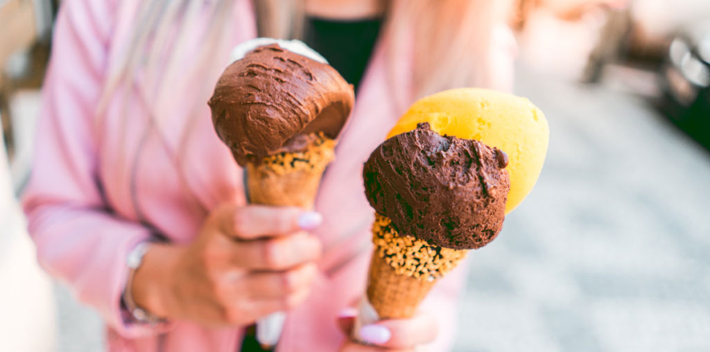 Young woman with two ice cream cones.