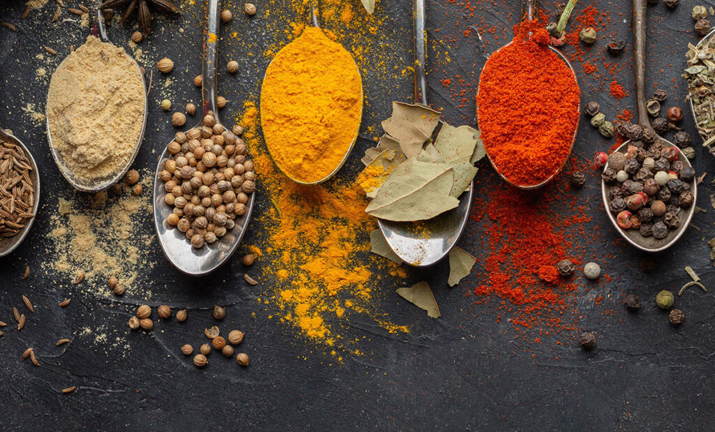 Looking down at different herbs on a spoon.