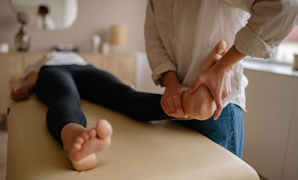 Man massaging woman's foot.