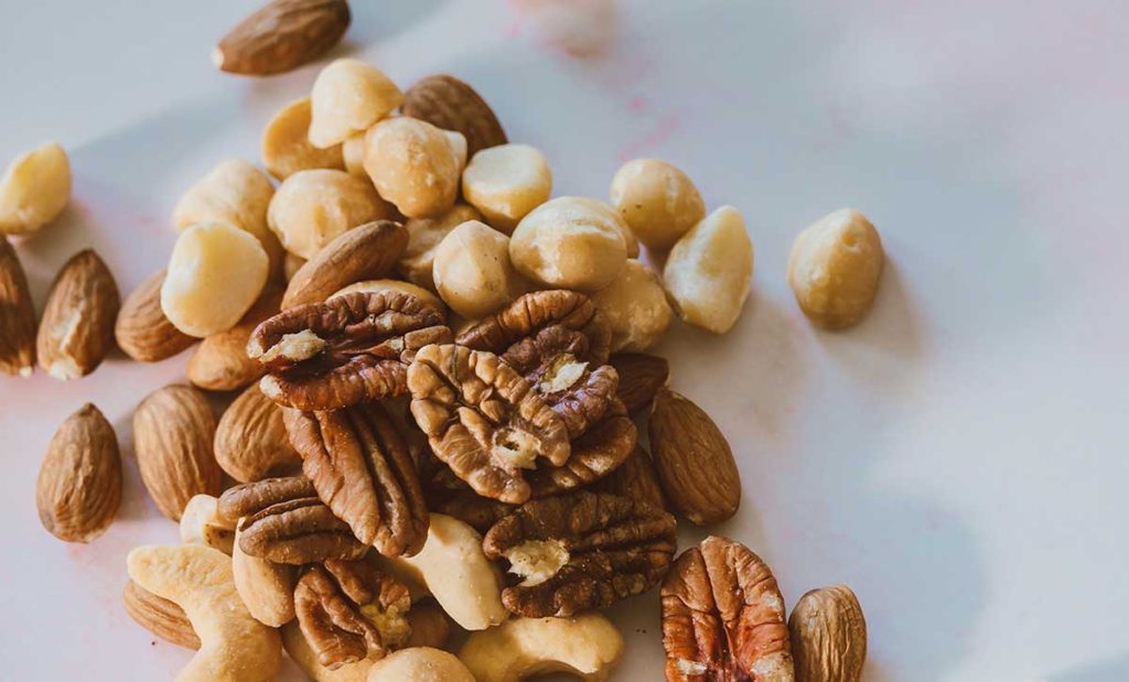 Mixed nuts spilled on table.