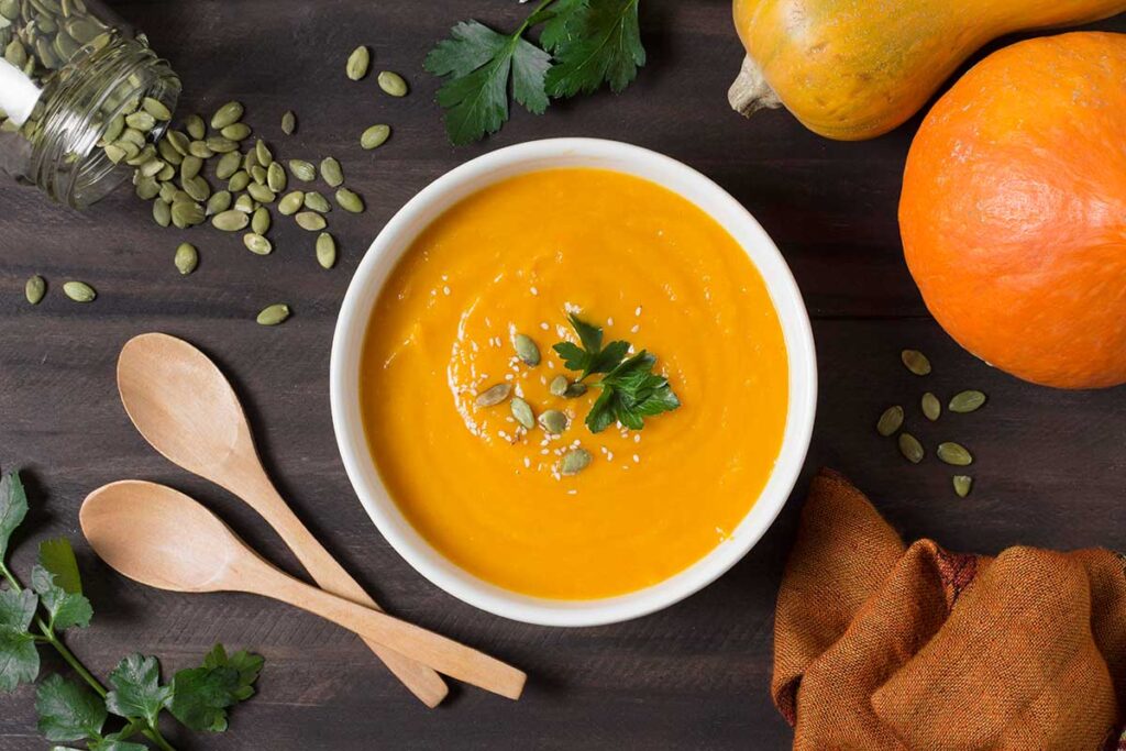 Looking down at pumpkin soup with pumpkin seeds.