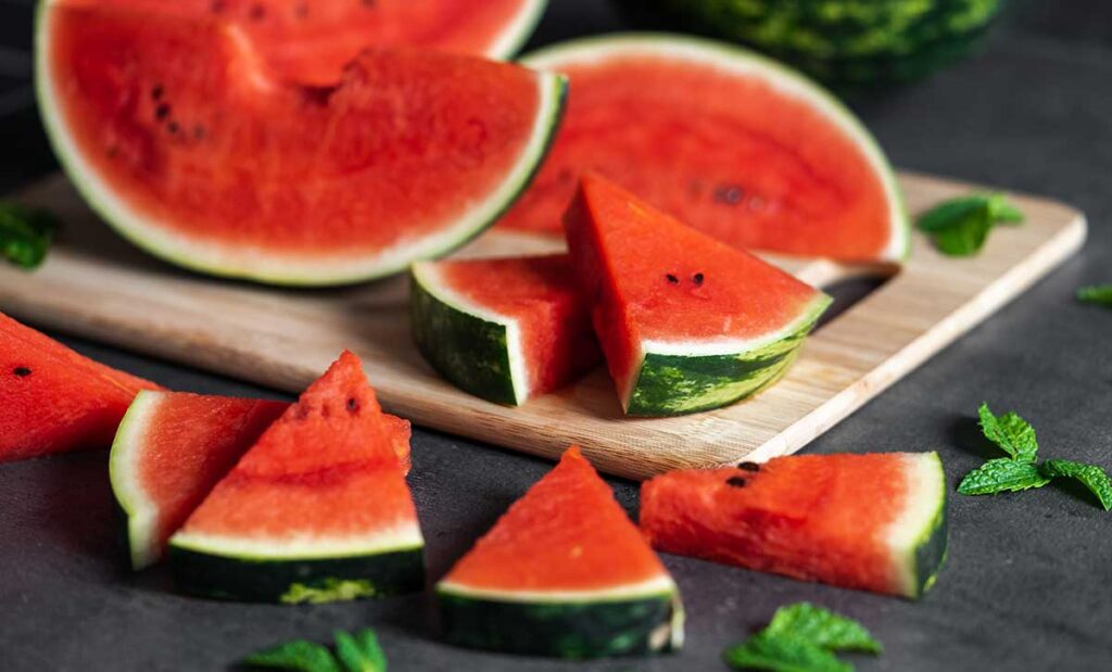 Slices of watermelon on a cutting board.