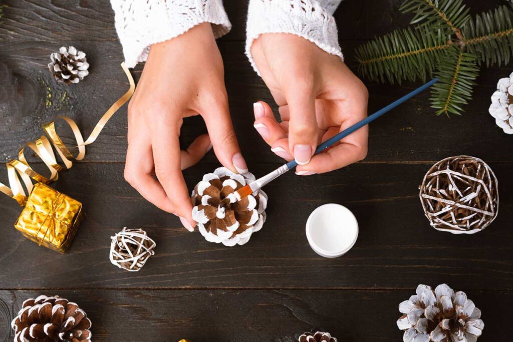 Top view of woman making Christmas decorations.