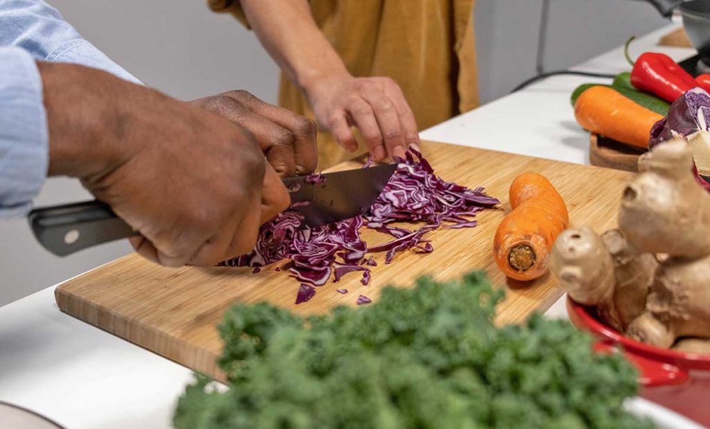 Two people preparing veggies.