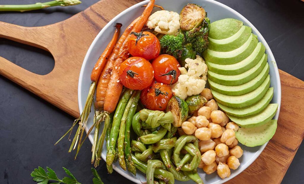 Vegetarian buddha bowl with fresh vegetable salad and chickpeas.