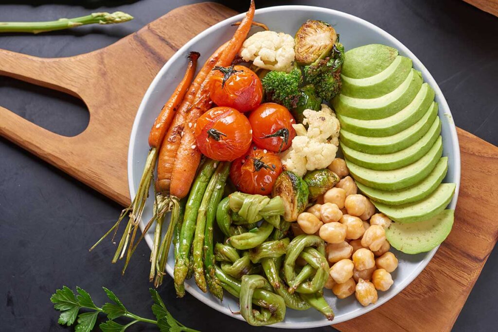 Vegetarian Buddha bowl with fresh vegetable salad and chickpea.