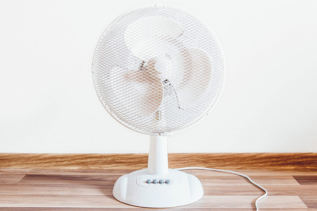 White oscillating table fan.