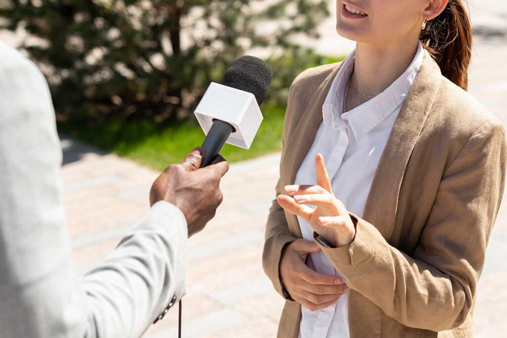 Woman being interviewed by a journalist.