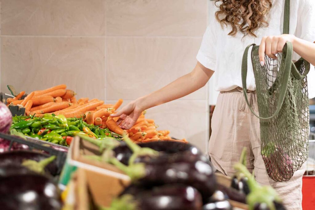 Woman buying vegetables.