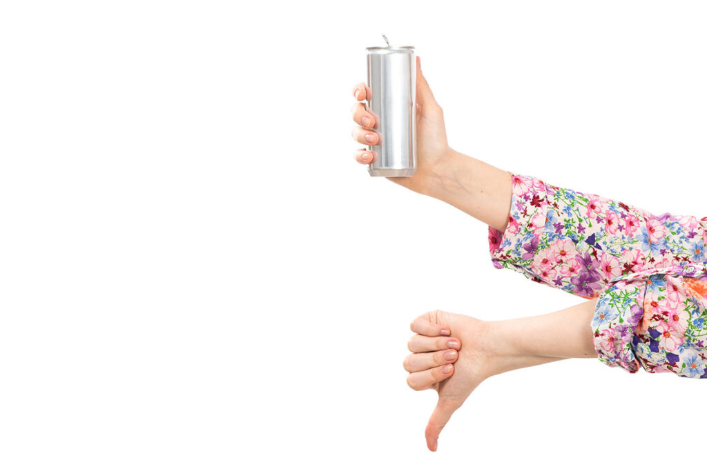 Woman in flower shirt holding silver can with other hand showing thumbs down.