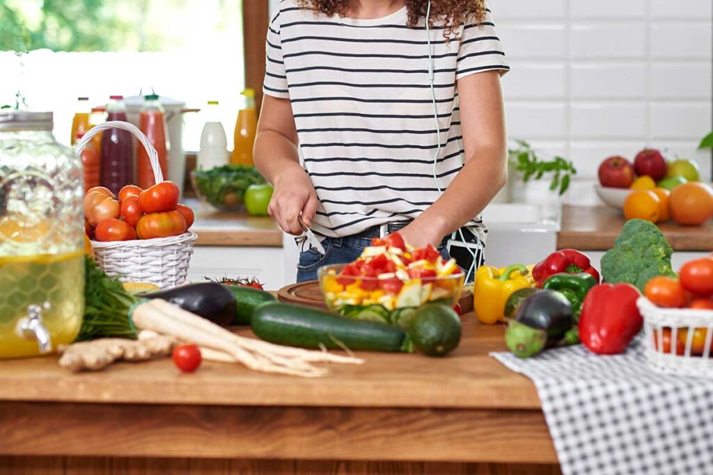 Woman chopping veggies.