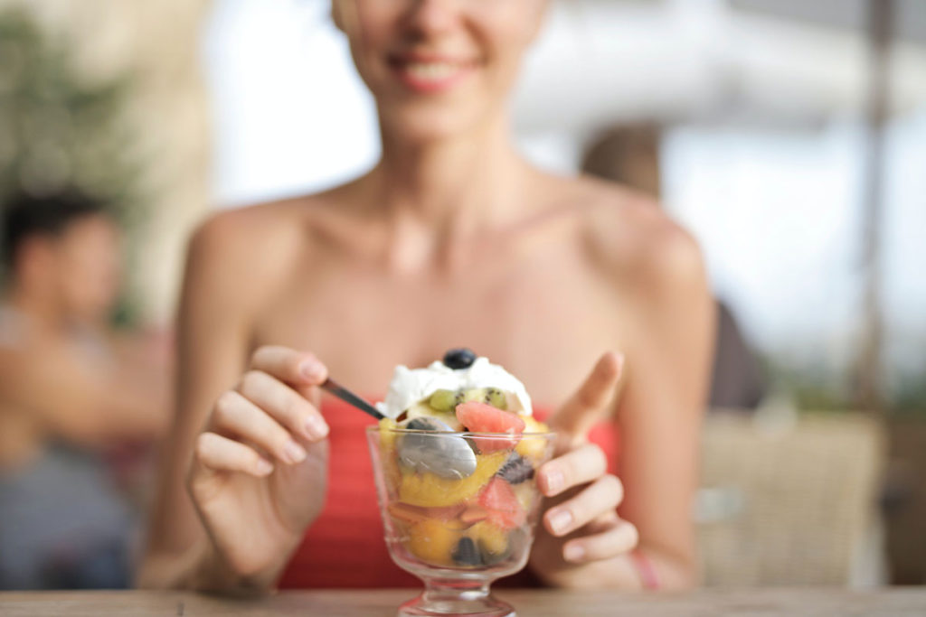 Woman eating fruit.