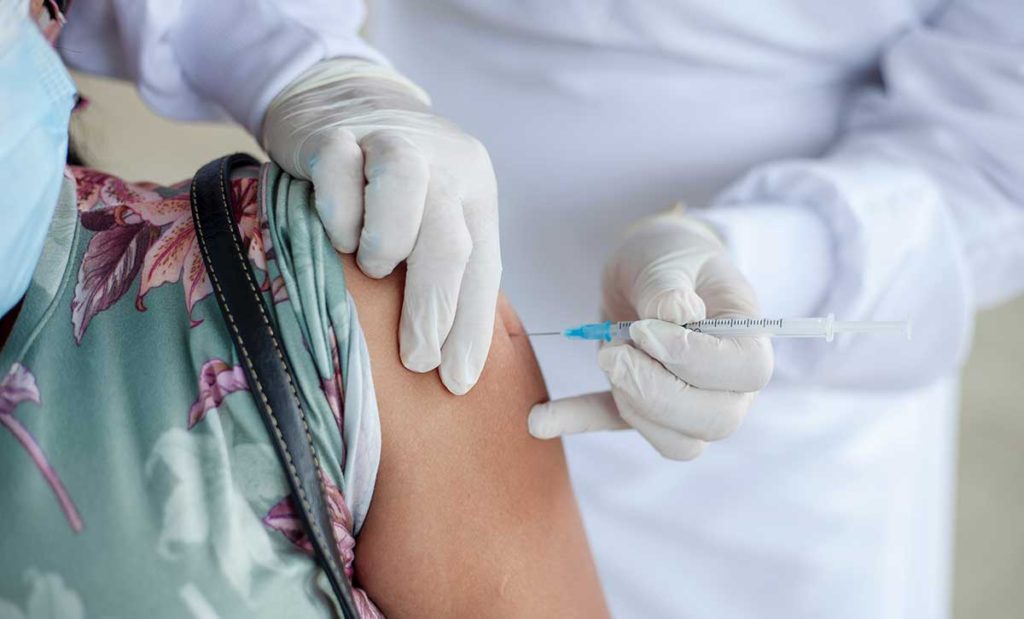 A woman getting a vaccine.