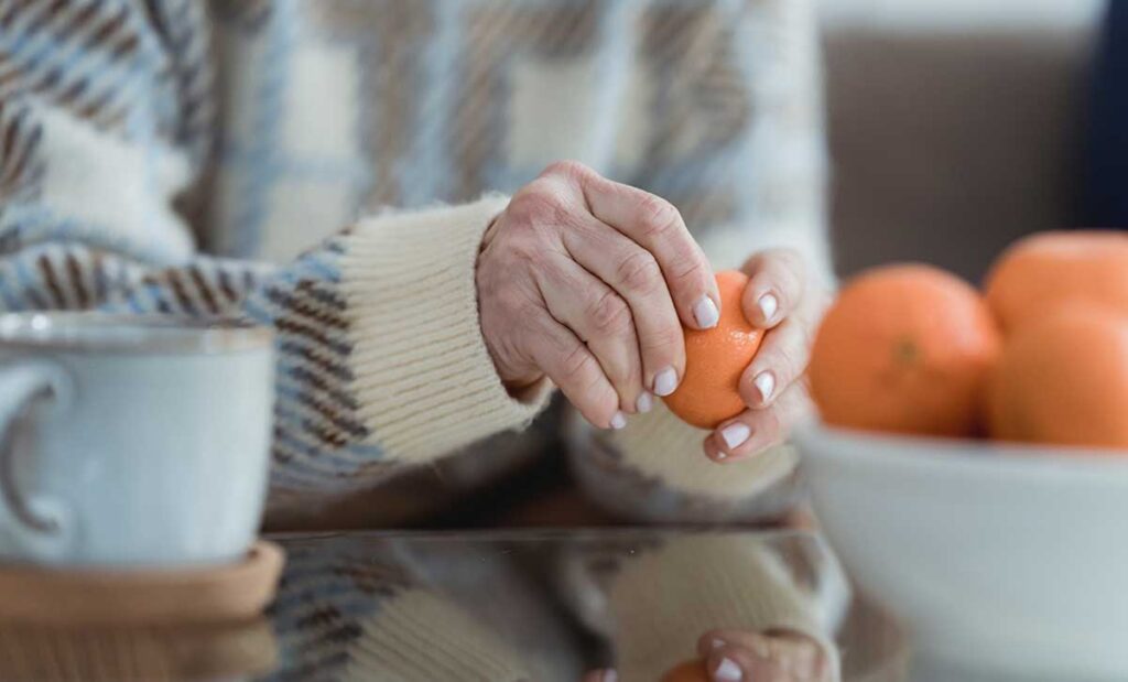 Woman peeling an orange.